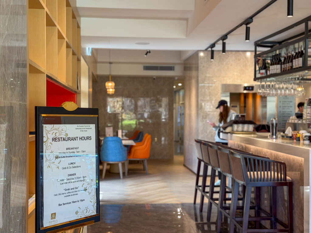 Hotel restaurant bar and dining area with timber shelving and bar stools
