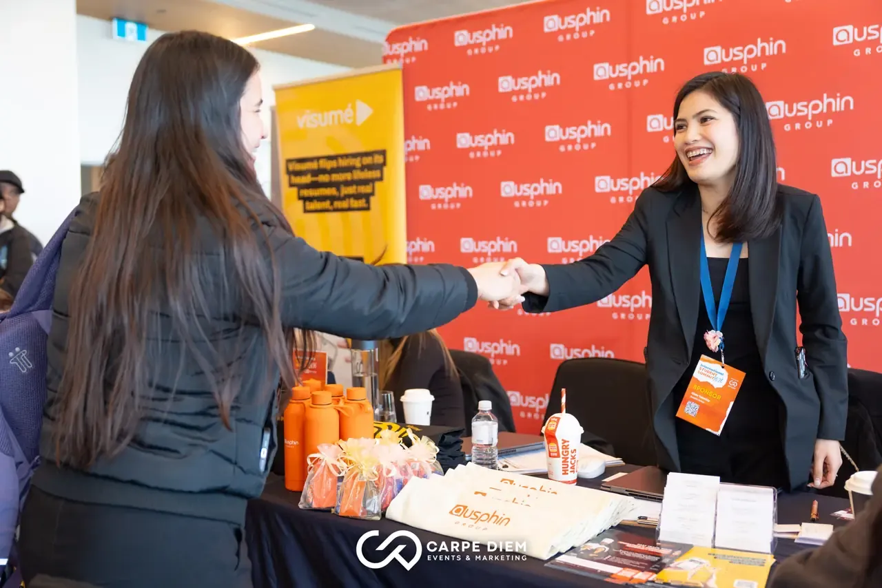 Exhibitor shaking hands with a student at an International Student Summit expo stall in Perth
